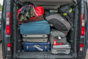Van packed full with luggage for a trip.